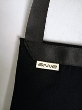 Afbeelding in Gallery-weergave laden, Classy crossbody bag handmade from the sleeve of a reused suit jacket, designed by Anne van Dijk, Color Black, Photo of label