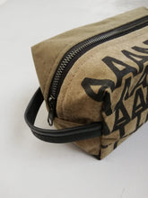 Load image into Gallery viewer, Canvas toiletry bag Amsterdam from recycled military canvas and bicycle inner tube, designed by Anne van Dijk. Photo 2 Hanging loop
